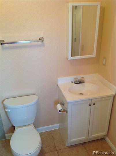 3210 West Longfellow Place Denver, CO 80221 - Photo 33 of 36 a bathroom with a toilet sink and mirror