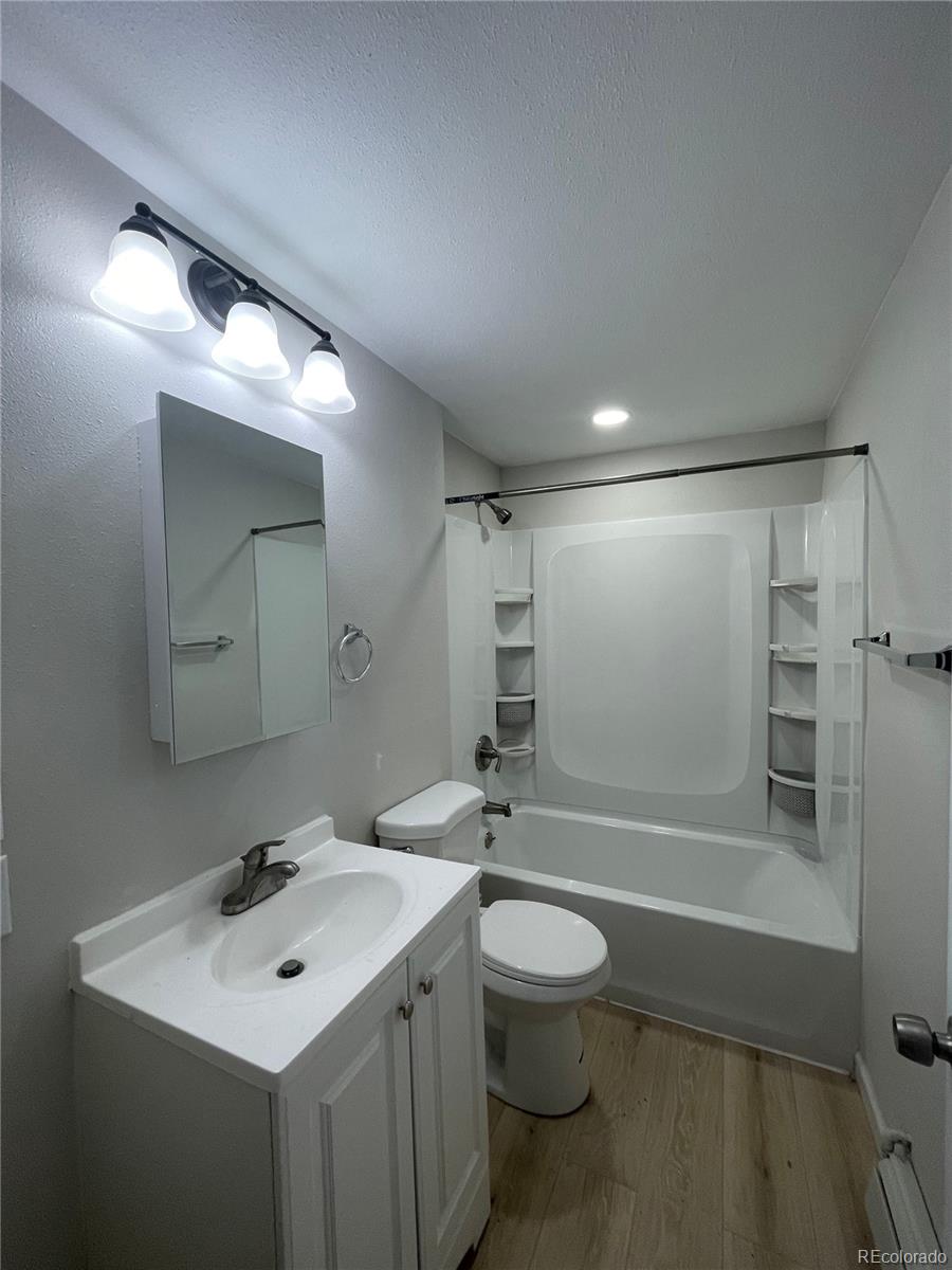 3210 West Longfellow Place Denver, CO 80221 - Photo 6 of 36 a bathroom with a sink a toilet and shower