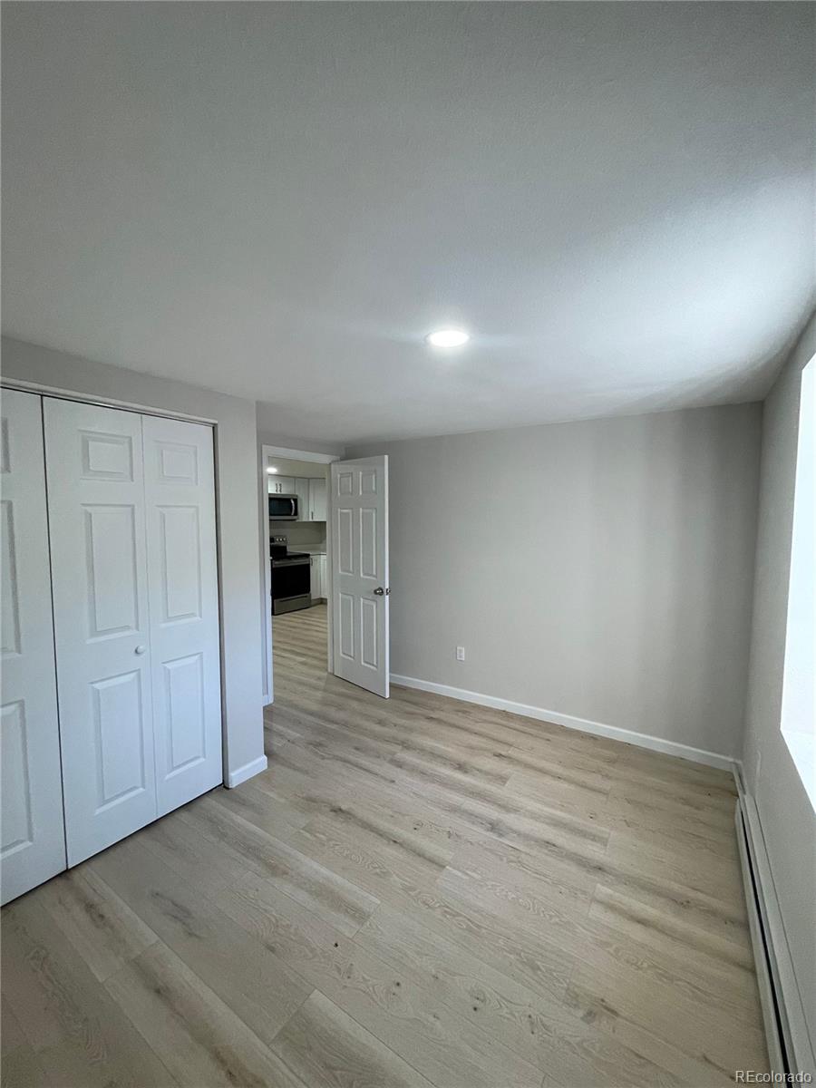 3210 West Longfellow Place Denver, CO 80221 - Photo 10 of 36 a view of empty room with wooden floor
