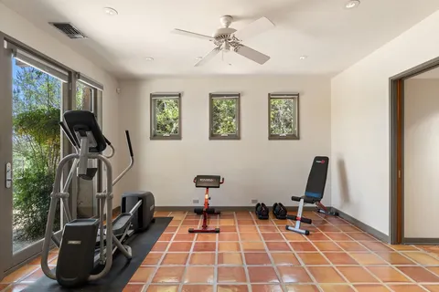 a room with gym equipment and a mirror