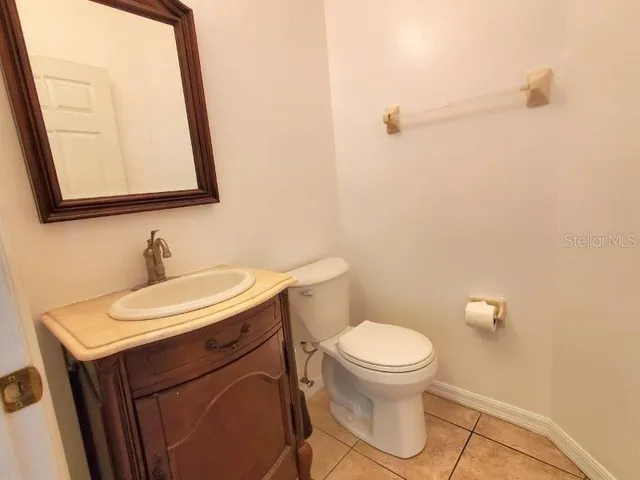 an empty room with windows and chandelier fan