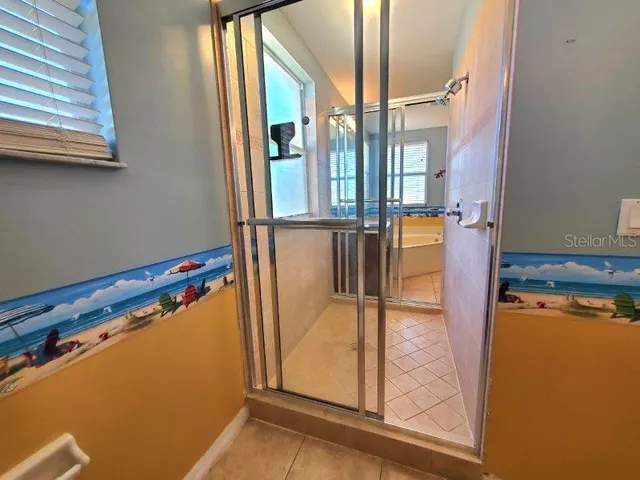 a spacious bathroom with a tub sink and mirror