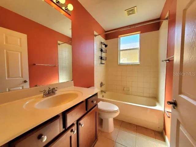 a bathroom with a tub sink and mirror