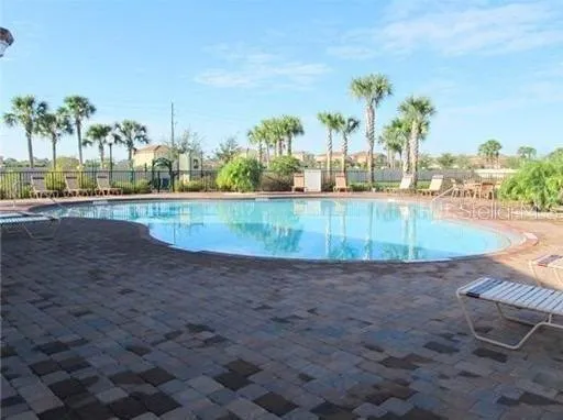 view of a swimming pool with a yard