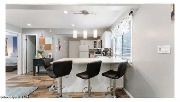 a kitchen with stainless steel appliances kitchen island granite countertop a table and chairs
