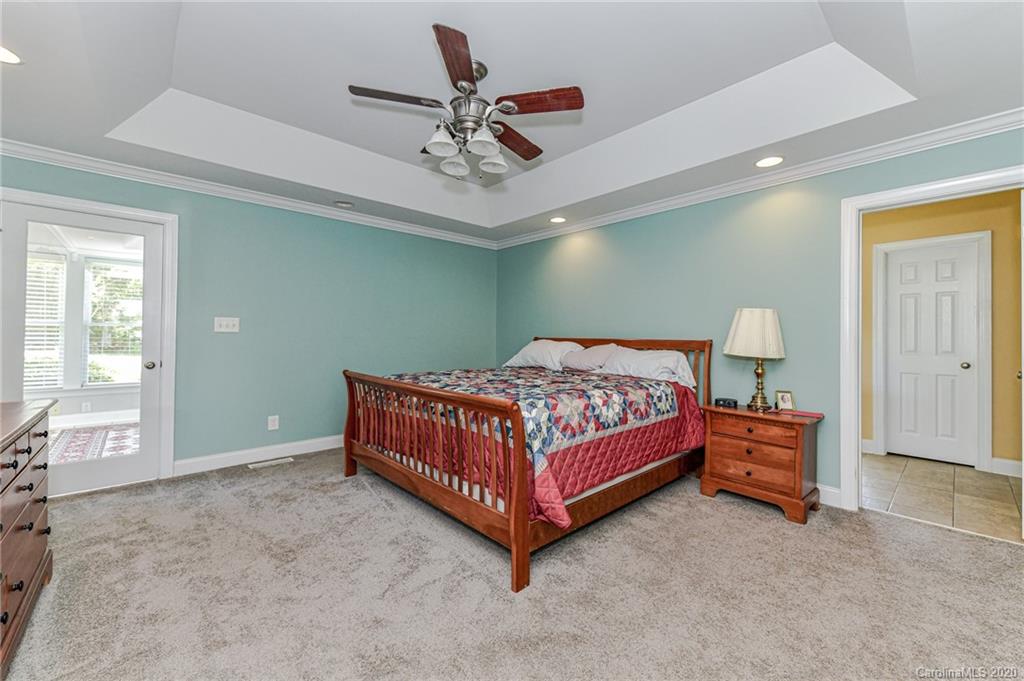150 North Moose Road Mount Pleasant, NC 28124 - Photo 11 of 32 a bedroom with a bed and a chandelier