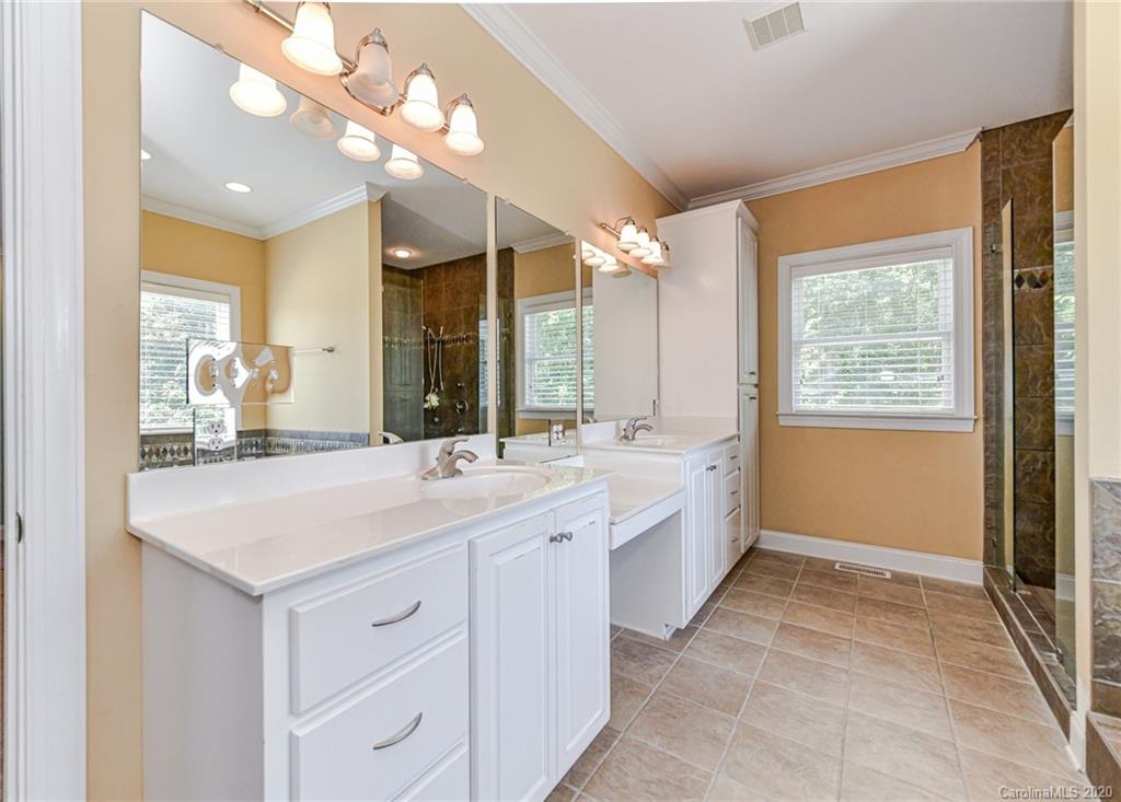 150 North Moose Road Mount Pleasant, NC 28124 - Photo 13 of 32 a bathroom with a sink a vanity and a large mirror