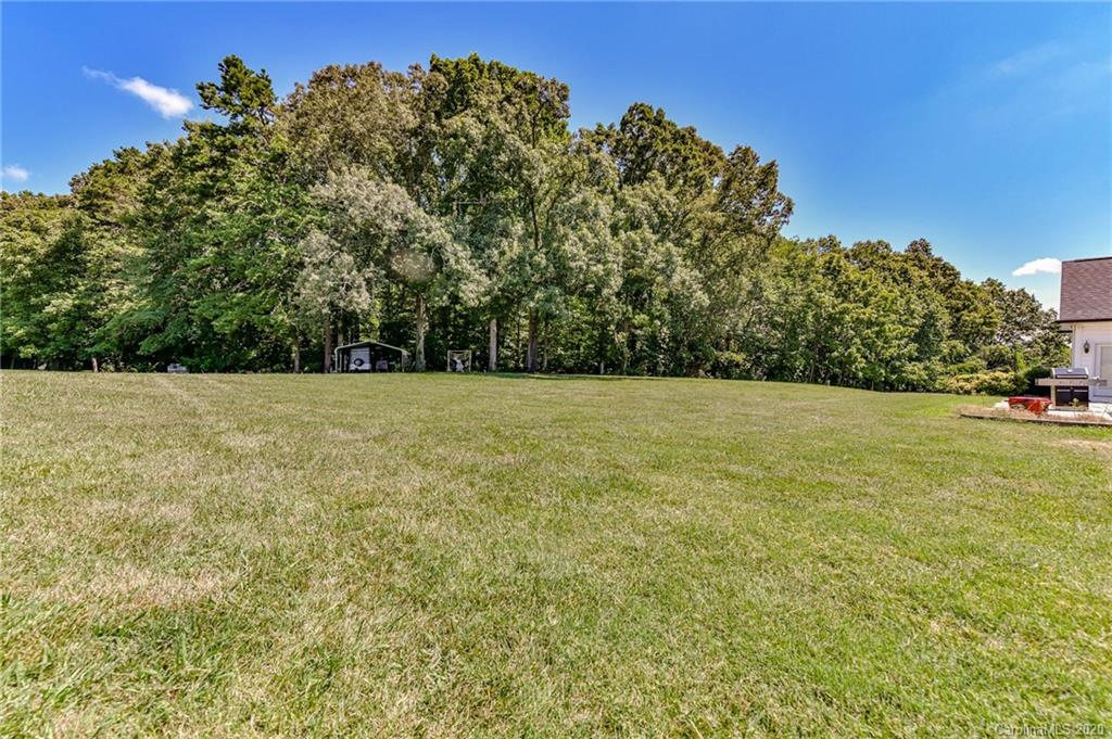 150 North Moose Road Mount Pleasant, NC 28124 - Photo 30 of 32 a view of a field with trees in the background