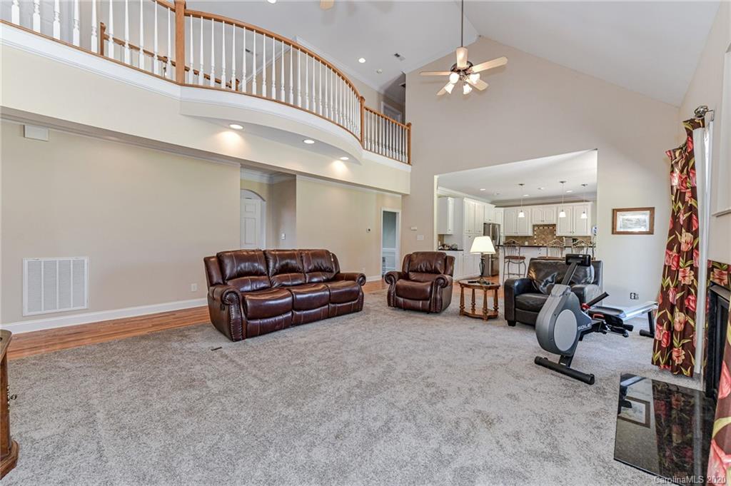 150 North Moose Road Mount Pleasant, NC 28124 - Photo 6 of 32 a living room with furniture a ceiling fan and a rug