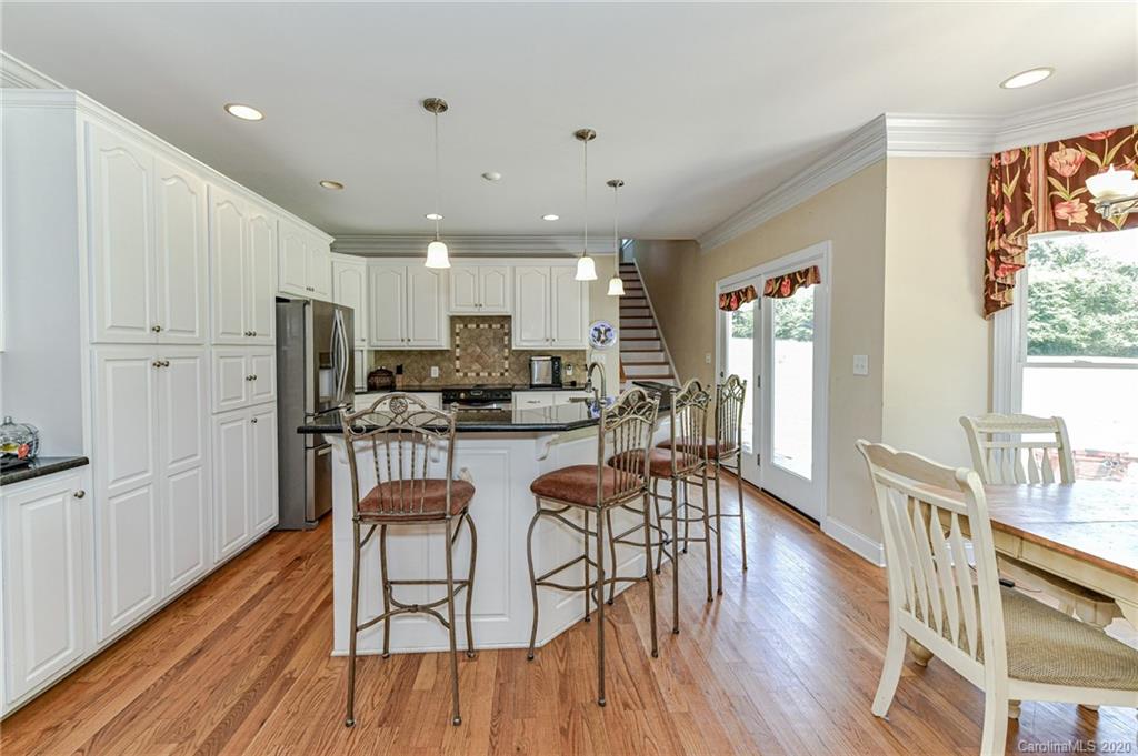 150 North Moose Road Mount Pleasant, NC 28124 - Photo 7 of 32 a view of a dining room with furniture and wooden floor