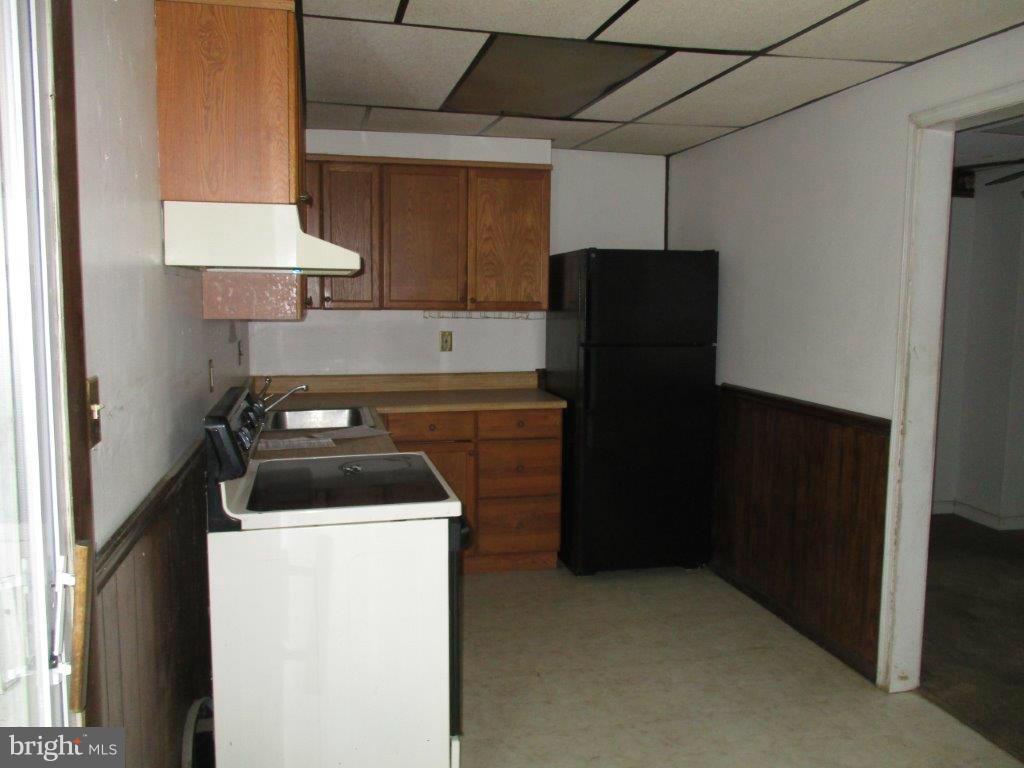 818 Thimbleberry Road Baltimore, MD 21220 - Photo 4 of 12 a kitchen with a stove and a refrigerator