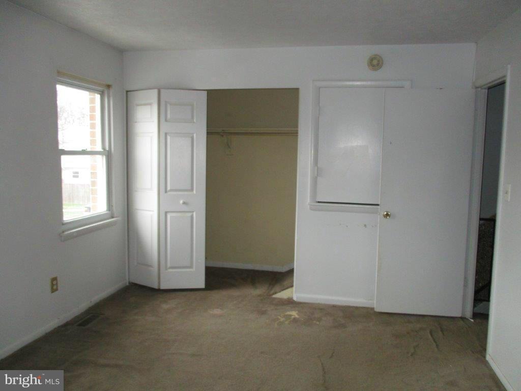 818 Thimbleberry Road Baltimore, MD 21220 - Photo 9 of 12 an empty room with windows and closet