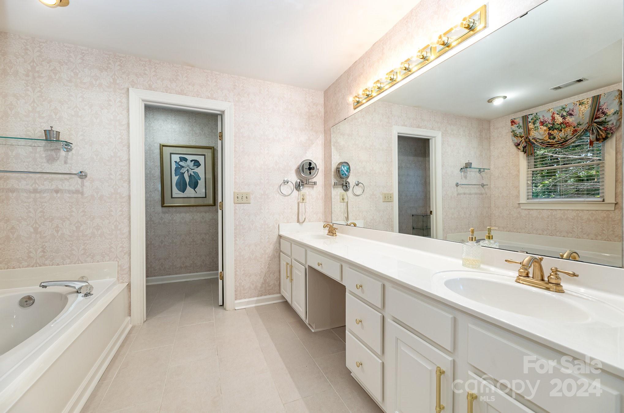 127 Polo Drive Salisbury, NC 28144 - Photo 17 of 31 a spacious bathroom with a granite countertop tub sink a mirror a shower and vanity