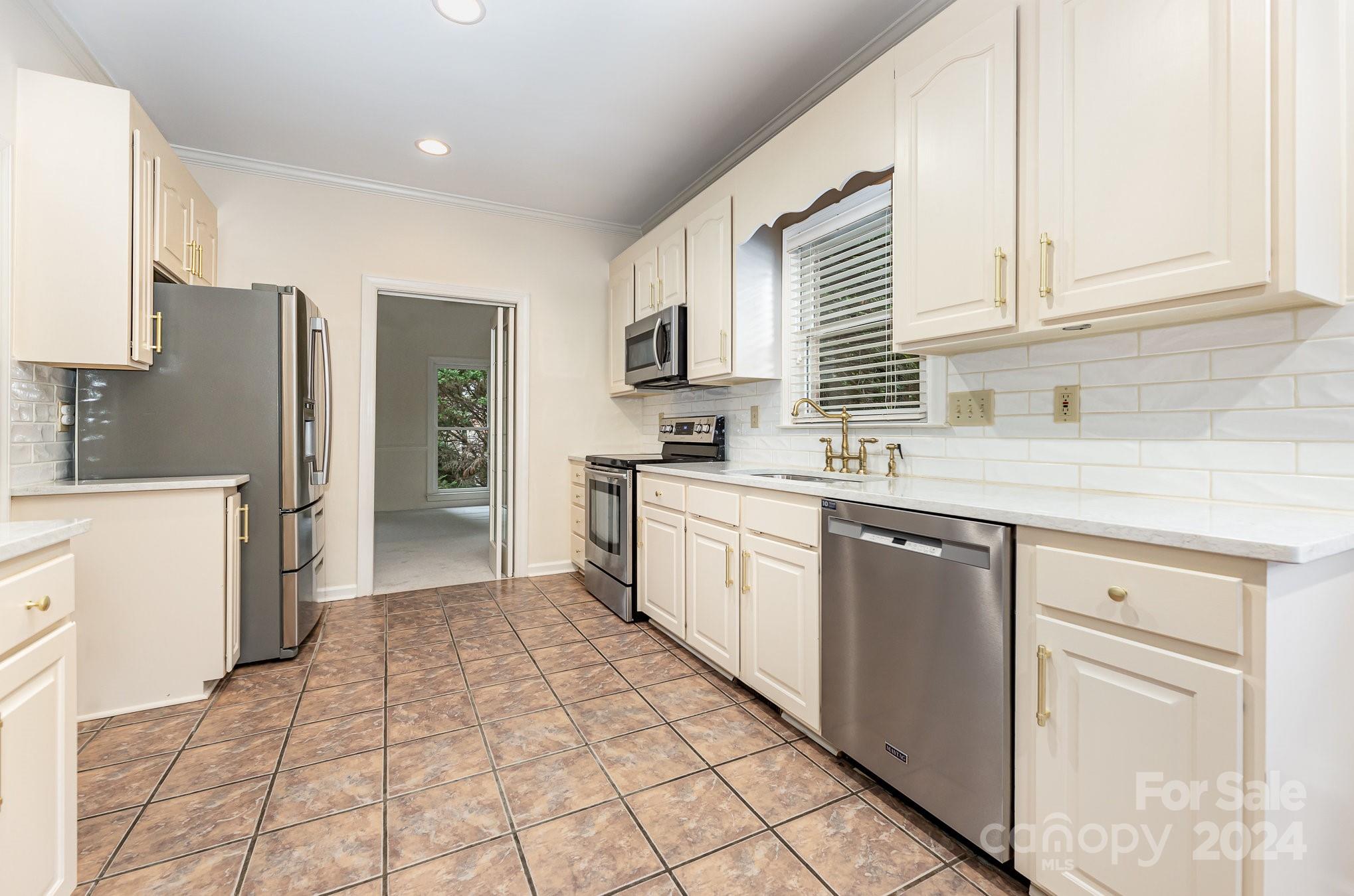 127 Polo Drive Salisbury, NC 28144 - Photo 8 of 31 a kitchen with a sink a counter top space cabinets and stainless steel appliances