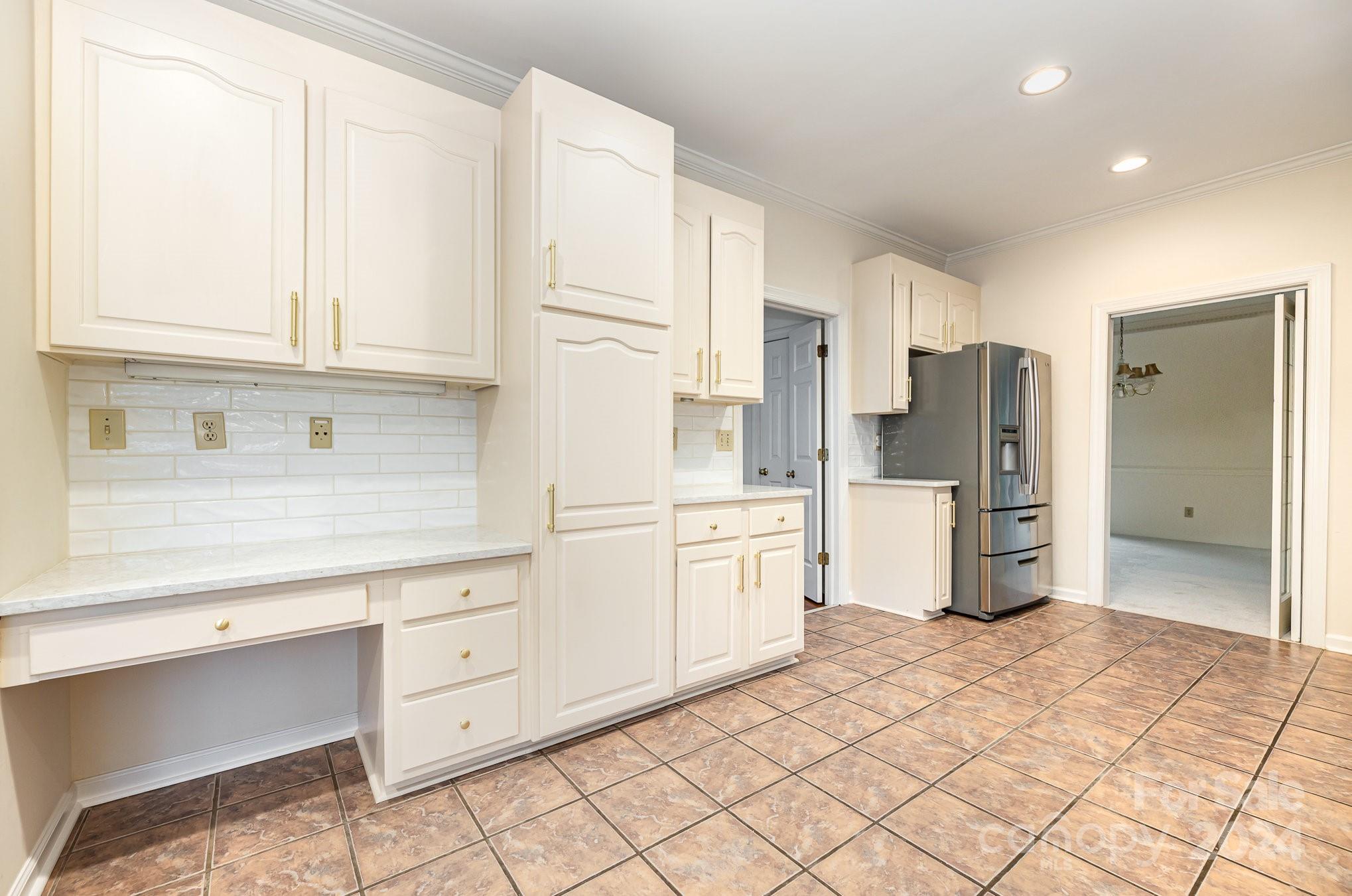 127 Polo Drive Salisbury, NC 28144 - Photo 9 of 31 a kitchen with white cabinets and refrigerator