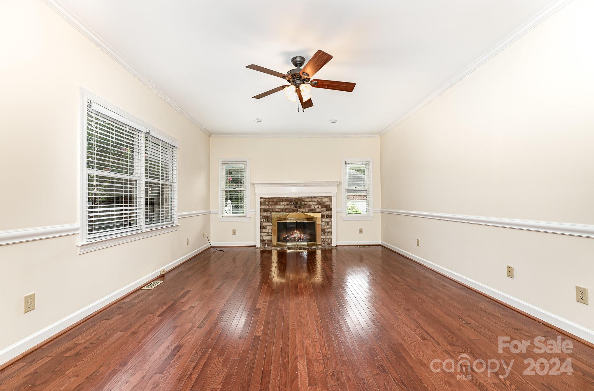 127 Polo Drive Salisbury, NC 28144 - Photo 10 of 31 a view of a livingroom with a fireplace a ceiling fan and wooden floor