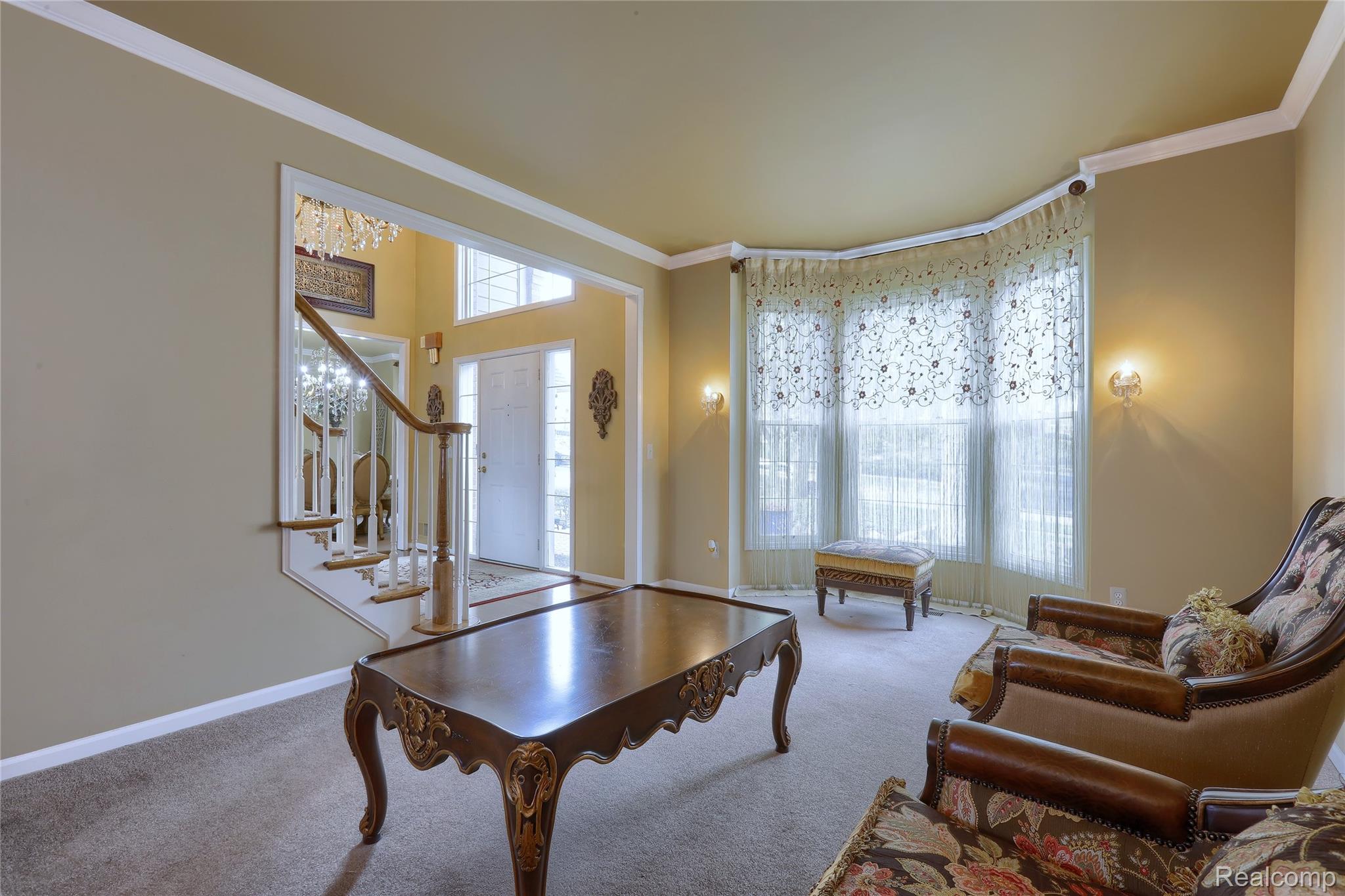 2007 Mapleridge Road Rochester, MI 48309 - Photo 7 of 45 Carpeted living room featuring crown molding and stairway