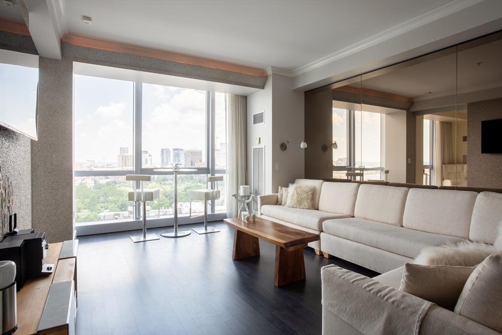 110 Stuart Street, Unit 23F Boston, MA 02116 - Photo 2 of 15 a living room with furniture and a large window
