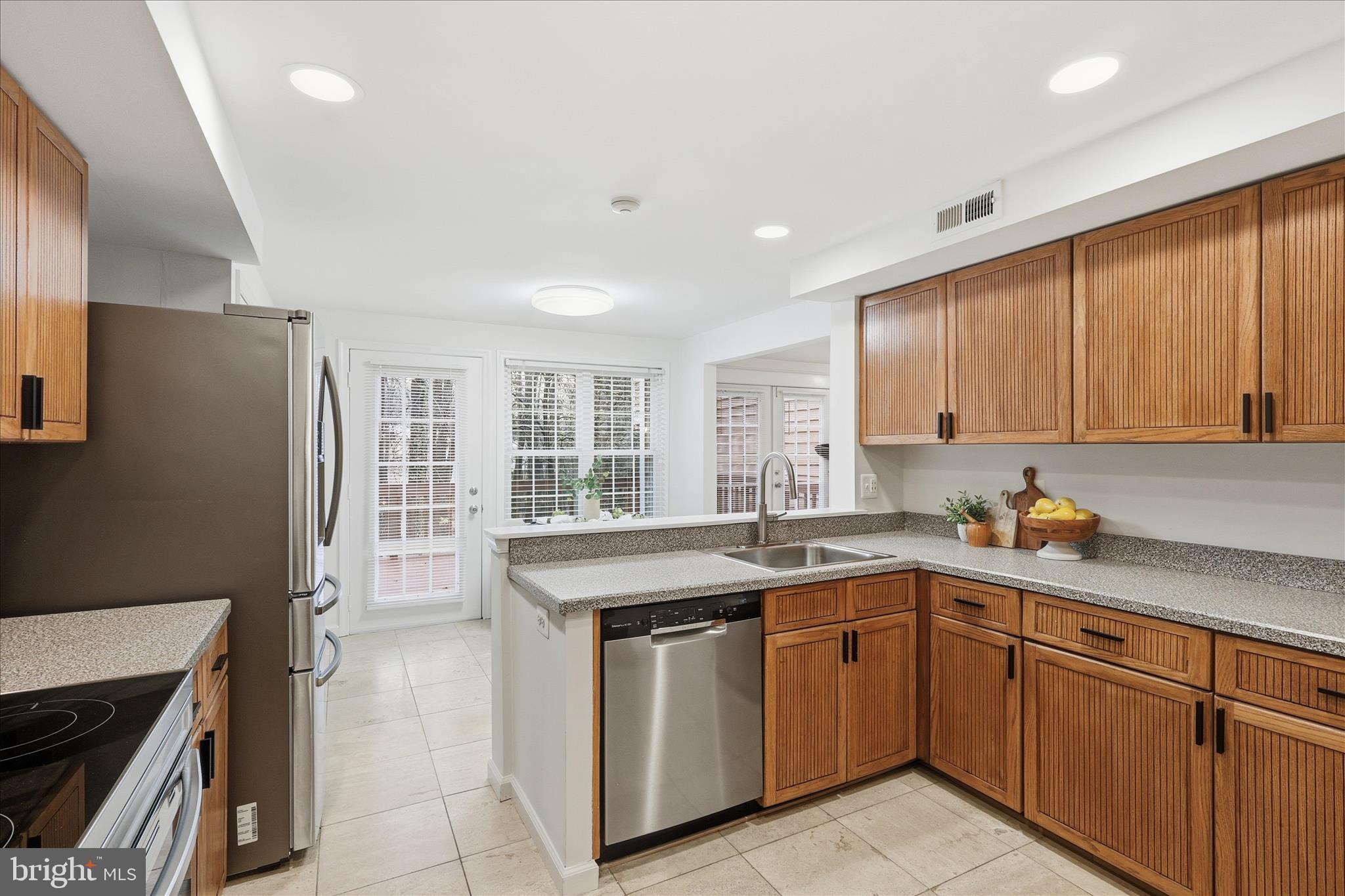 11725 Arbor Glen Way Reston, VA 20194 - Photo 13 of 63 a kitchen with a sink stove and cabinets