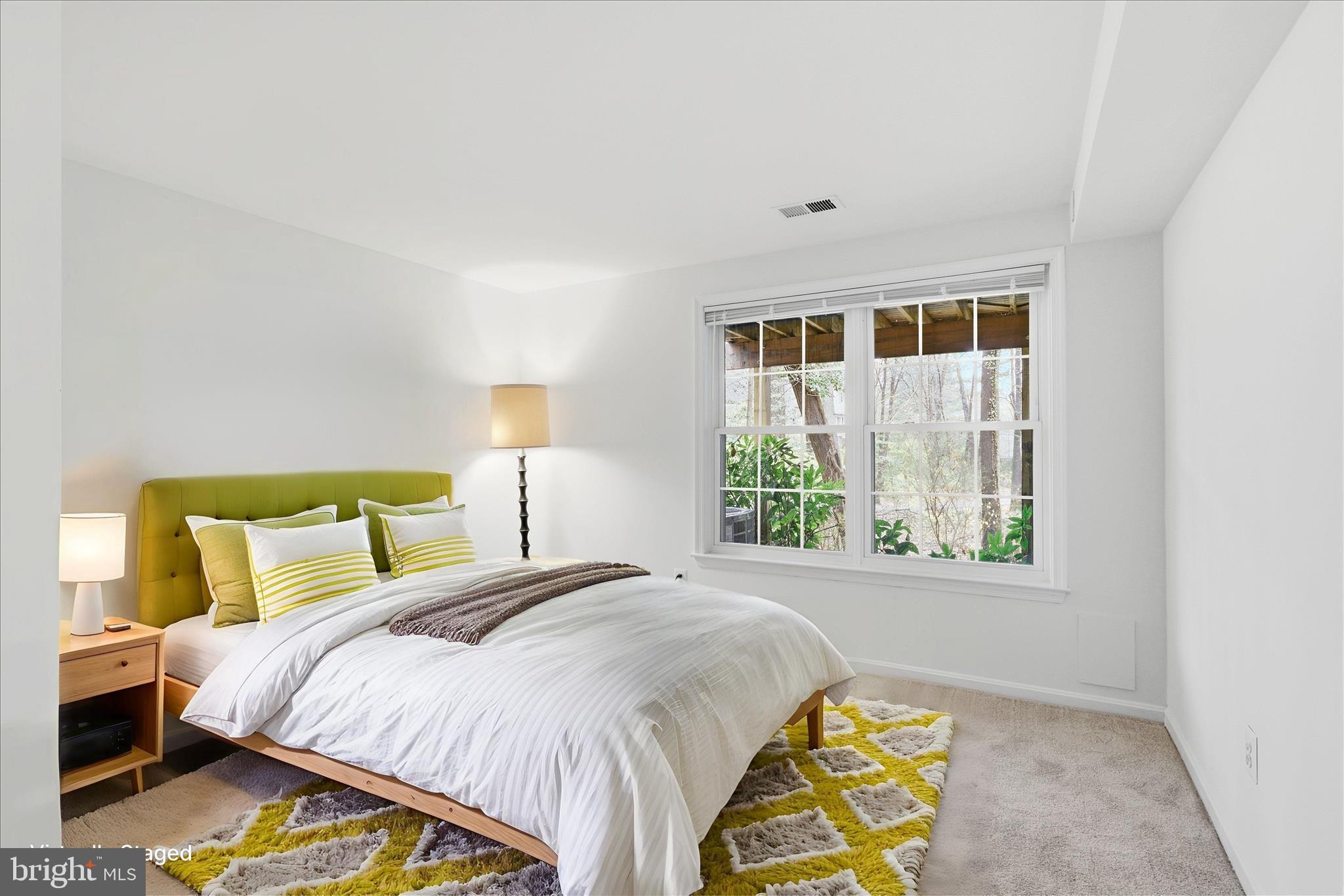 11725 Arbor Glen Way Reston, VA 20194 - Photo 32 of 63 a bed sitting in a bedroom next to a window