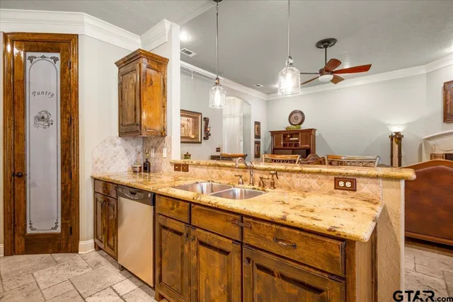 a kitchen with a sink appliances and cabinets