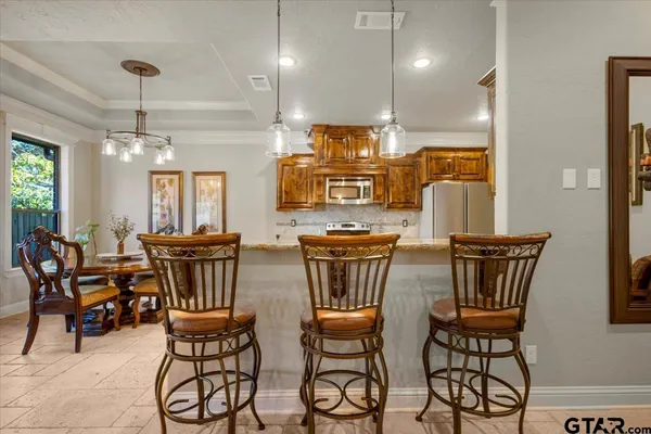a view of a dining room with furniture and chandelier