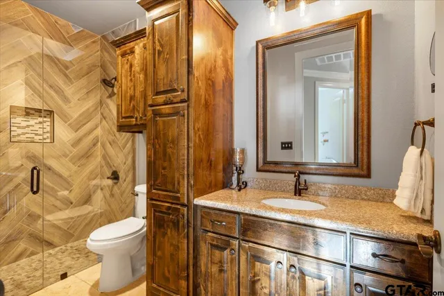 a bathroom with a sink toilet and shower