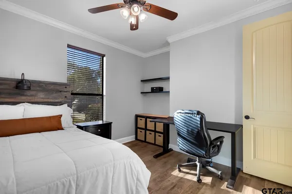 a bedroom with a bed and a chair