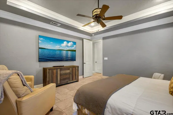 a bedroom with a bed and a flat screen tv