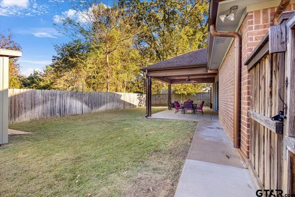 a view of a porch with furniture and garden