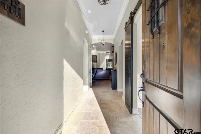a view of a hallway with furniture and stairs