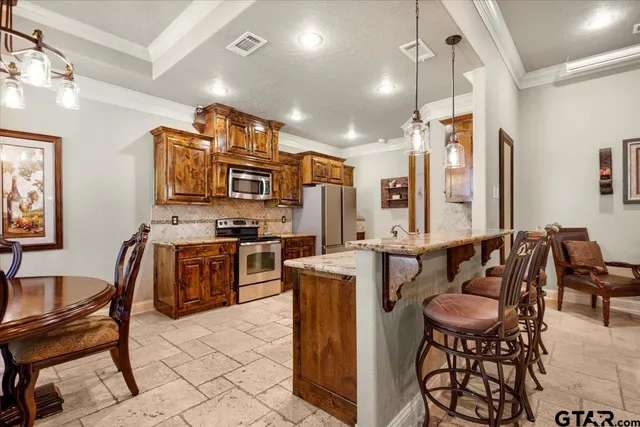 a view of kitchen with cabinets and stainless steel appliances