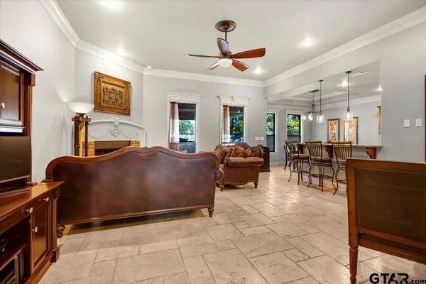 a living room with furniture a flat screen tv and a table