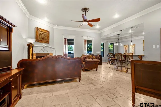 a living room with furniture a flat screen tv and a table
