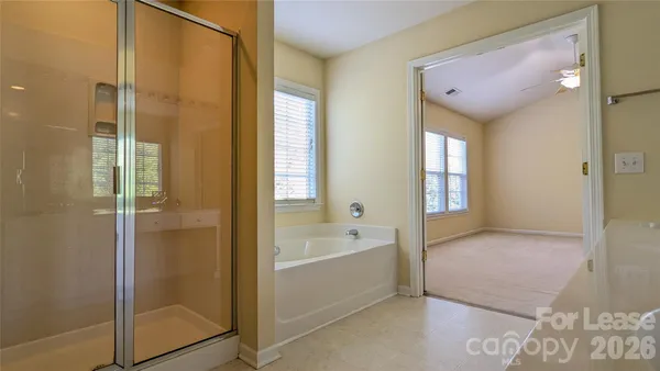 a bathroom with a tub shower and sink