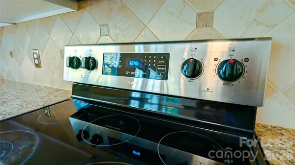a utility room with lots of clutter and cabinets