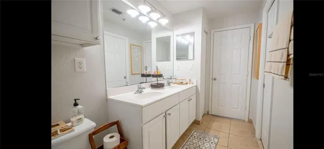a bathroom with a sink a mirror and a vanity