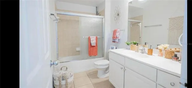 a bathroom with a sink toilet vanity and shower