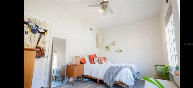 a living room with furniture and a painting on the wall