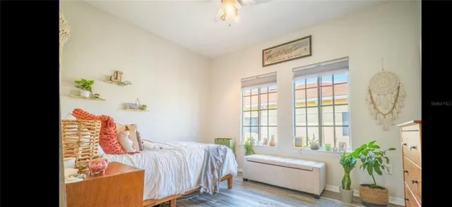 a bedroom with bed and a potted plant