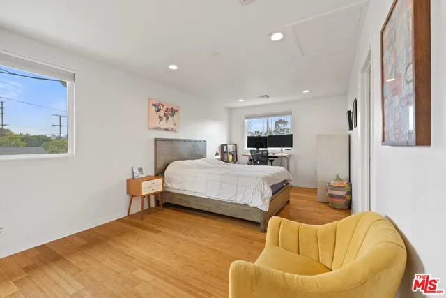 a bedroom with a bed and couch