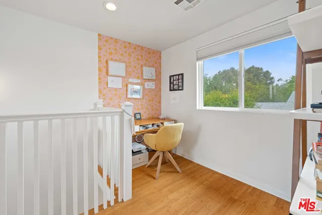 a view of a room with a window and a wooden floor