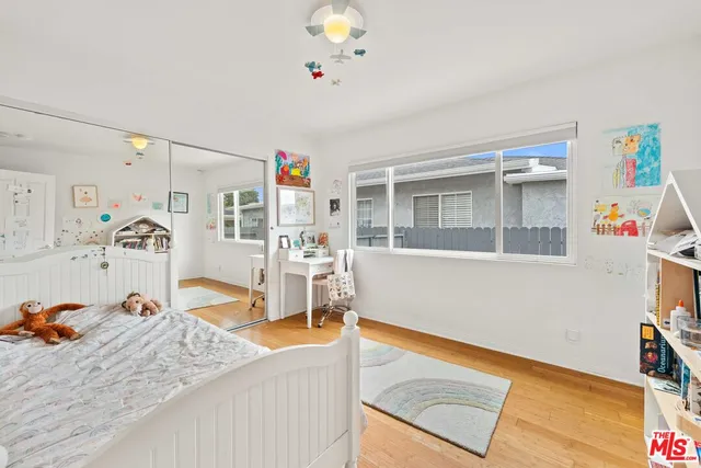 a bed room with a bed and a chair