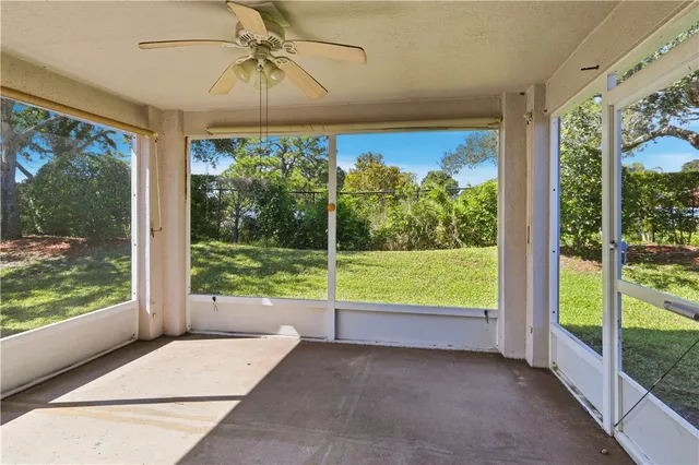 a view of a room that has a bed and glass door