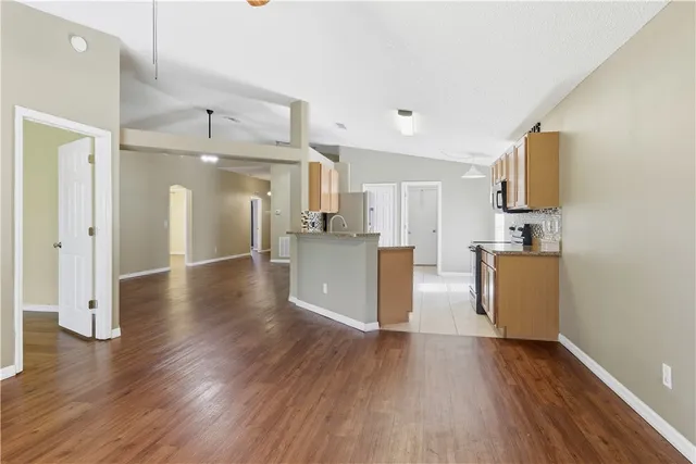 a view of a kitchen with a sink and a refrigerator