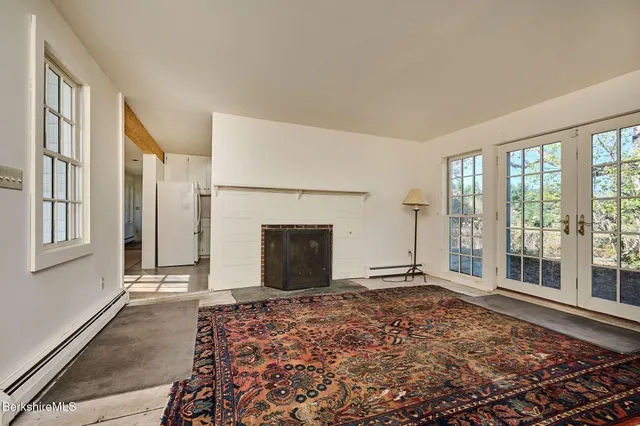 a living room with furniture a flat screen tv and a dining table