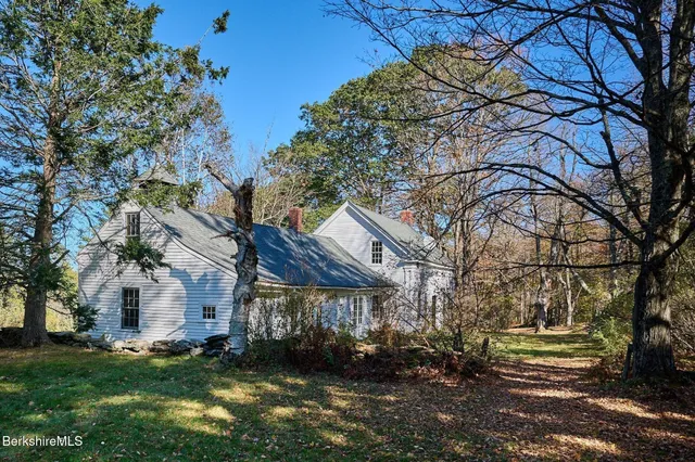 a view of an empty room with stairs and a window