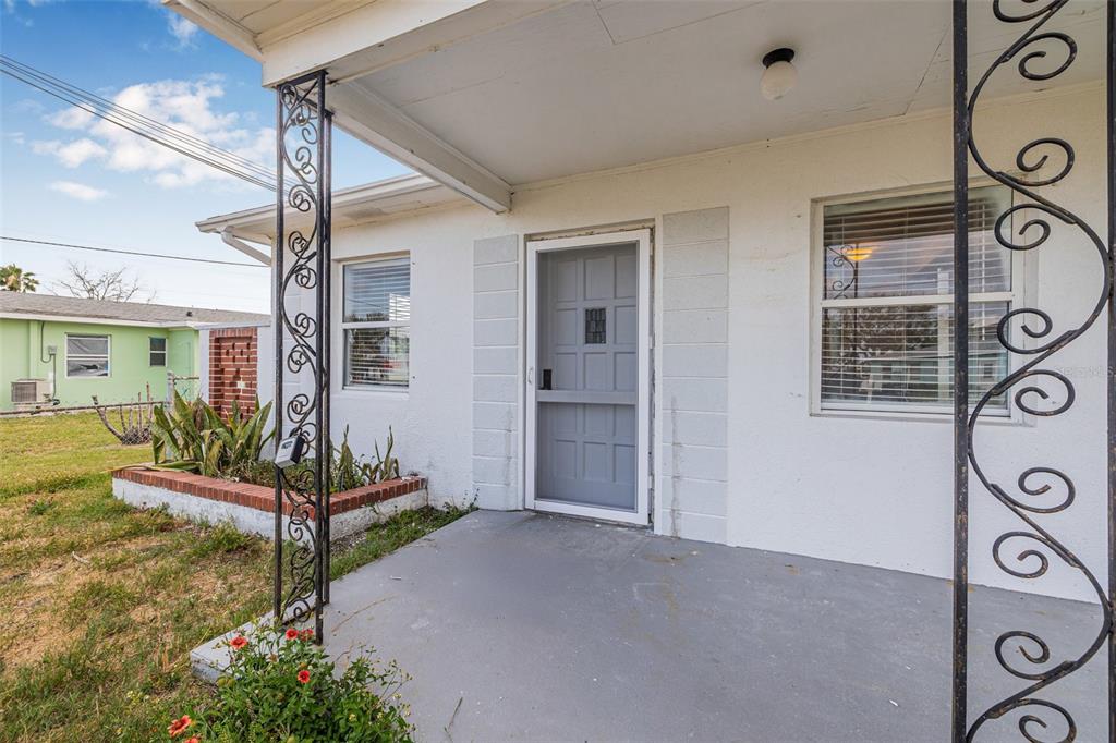 30 Lynn Way Madeira Beach, FL 33708 - Photo 12 of 16 a view of a house with a yard and potted plants