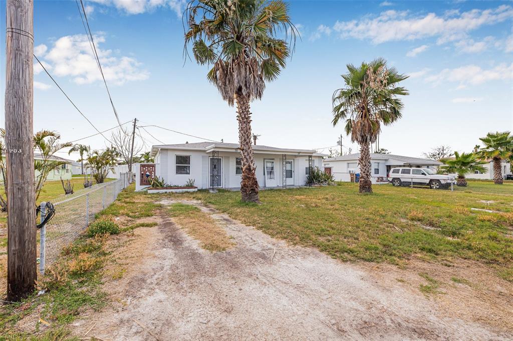 30 Lynn Way Madeira Beach, FL 33708 - Photo 16 of 16 a view of a house with palm trees and a small yard
