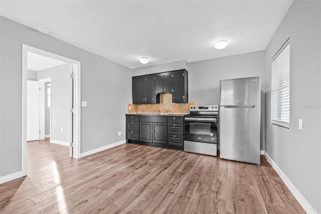 30 Lynn Way Madeira Beach, FL 33708 - Photo 3 of 16 a kitchen with a refrigerator and a stove top oven